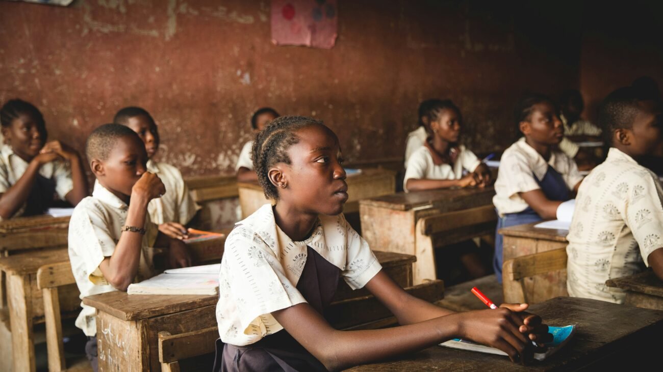 Children sitting on chairs inside classroom