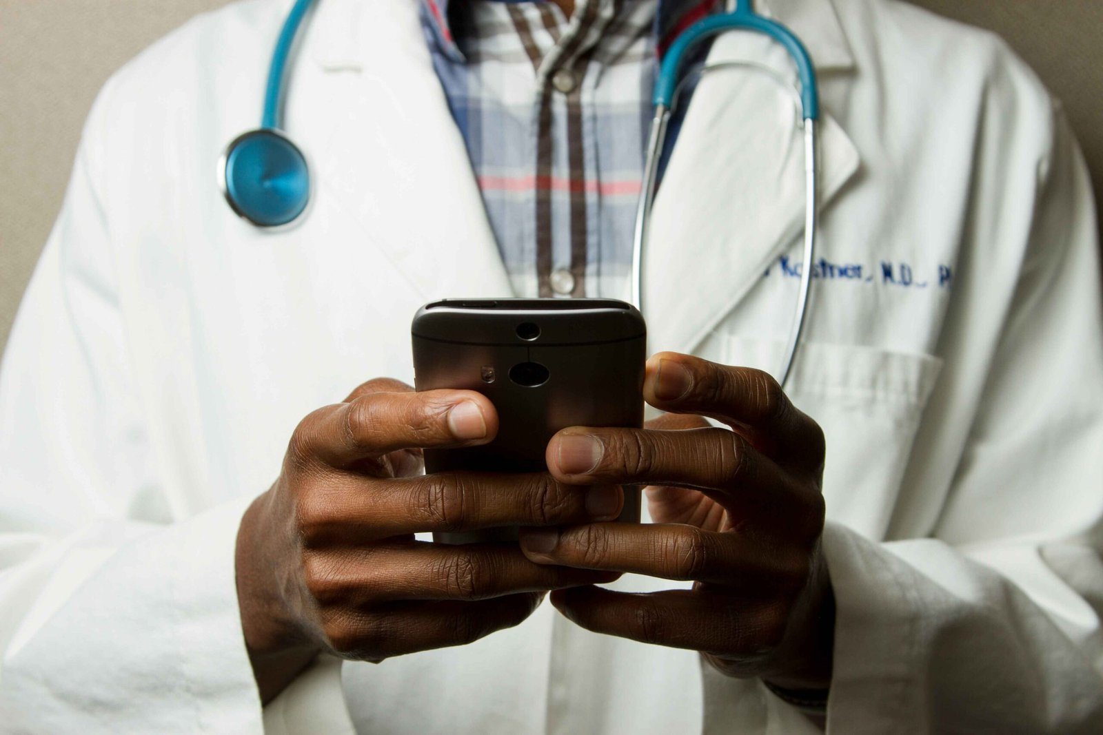 Photo of a doctor holding a phone